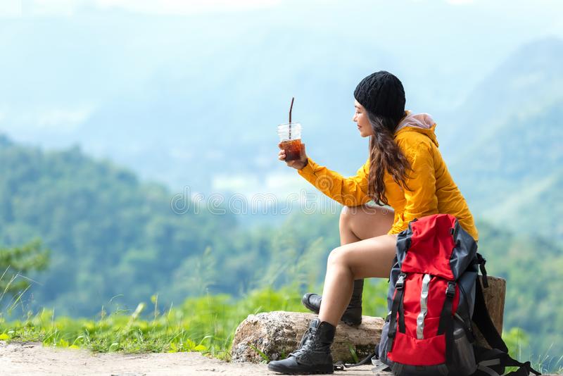 asian-woman-hiker-traveler-backpack-adventure-sitting-drinking-ice-coffee-relax-rest-mountain-outdoor-161967212
