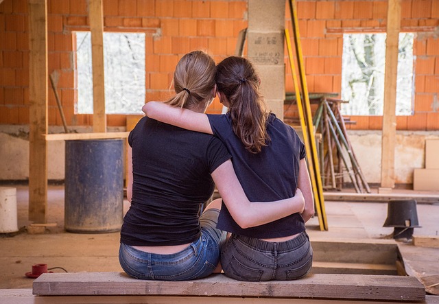 Dve ženy, ktoré sa pozerajú na dom vo výstavbe.jpg